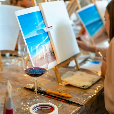 Sip and Paint Event. Painting with a glass of wine in hand